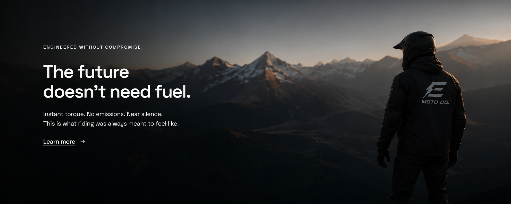 The future doesn't need fuel — rider overlooking mountain range at dusk